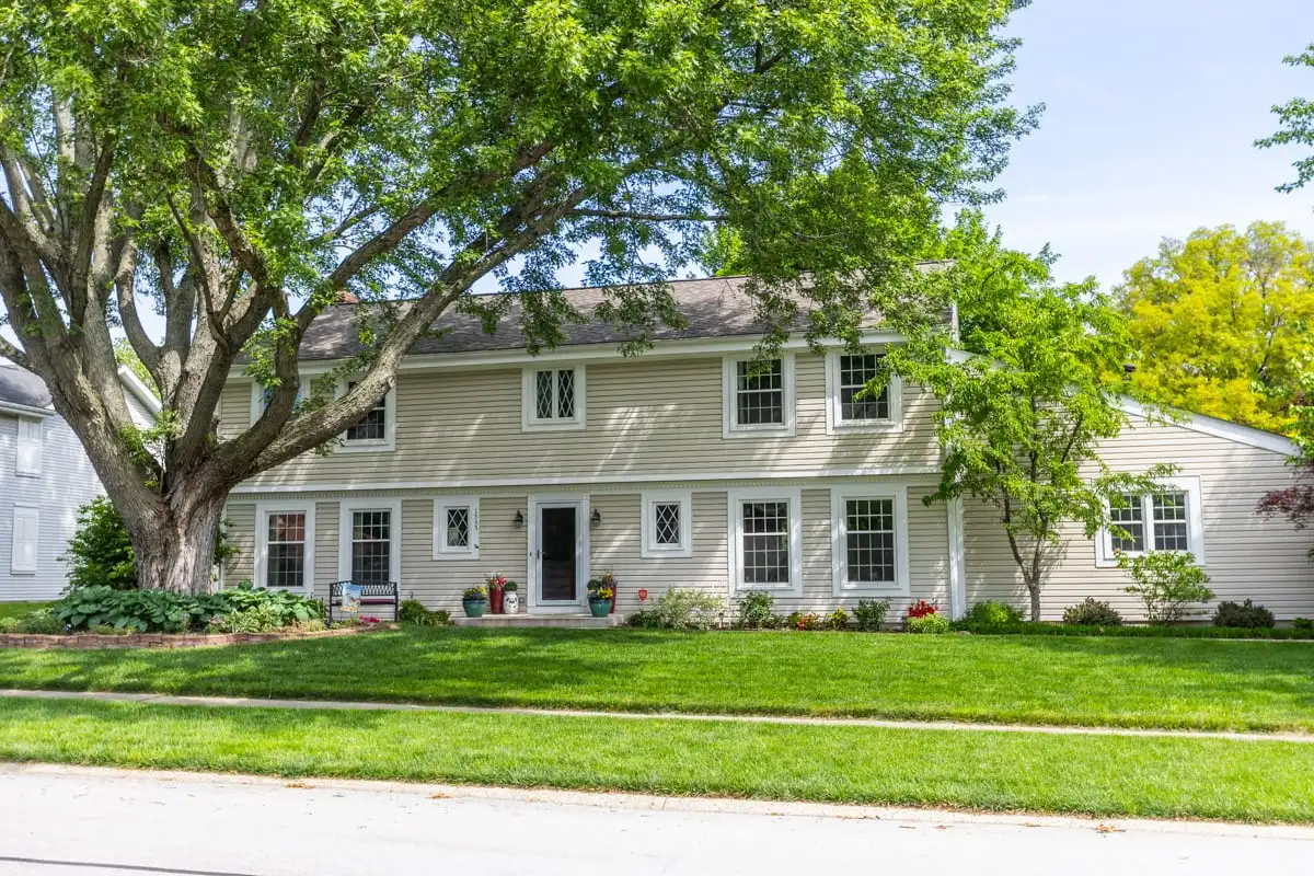 Broad green lawn in front of a two-story home