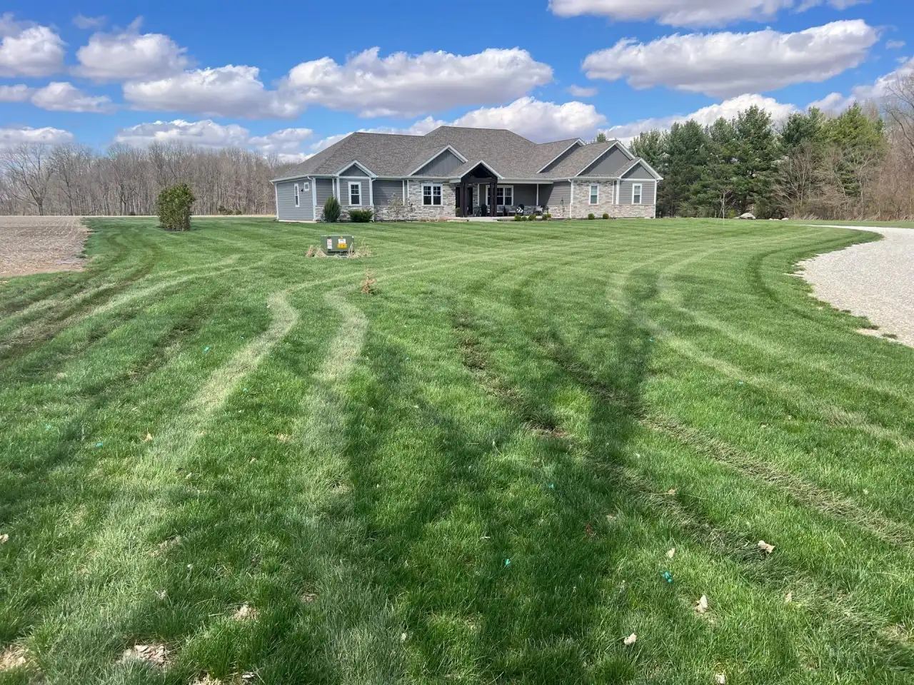 Curved mowing lines leading to a ranch home in Lafayette, Indiana