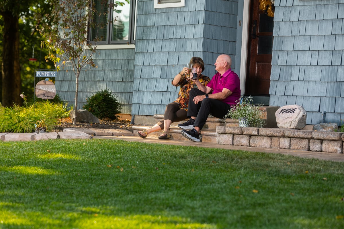 happy lawn care clients enjoying their grass