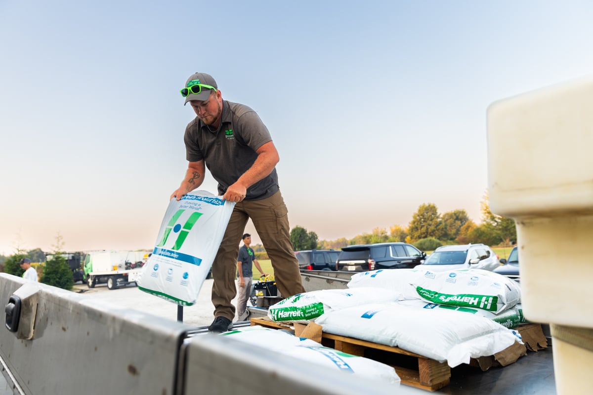 technician loading custom-blended fertilizer