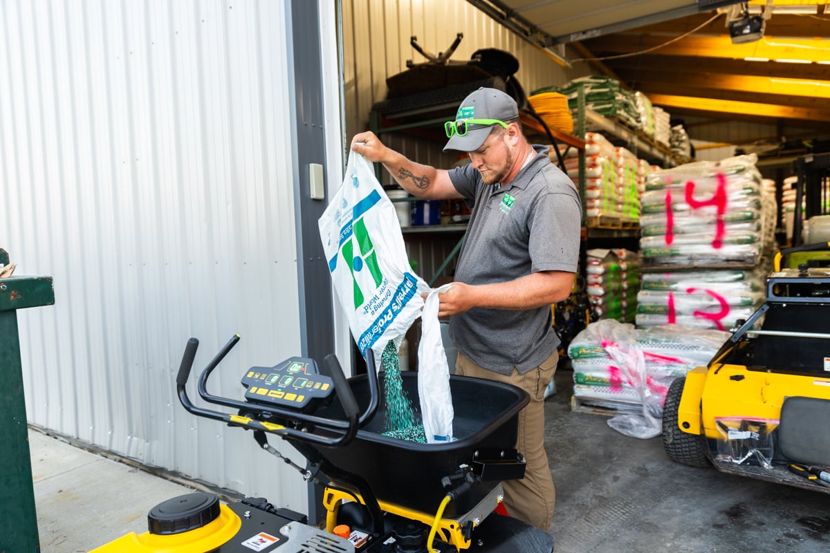 granular fertilizer being loaded into a hopper