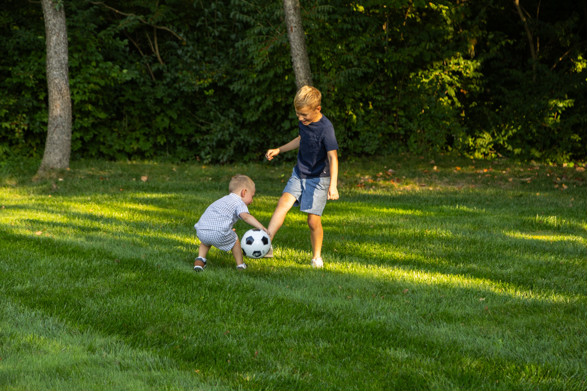 client family kids playing lawn grass 2