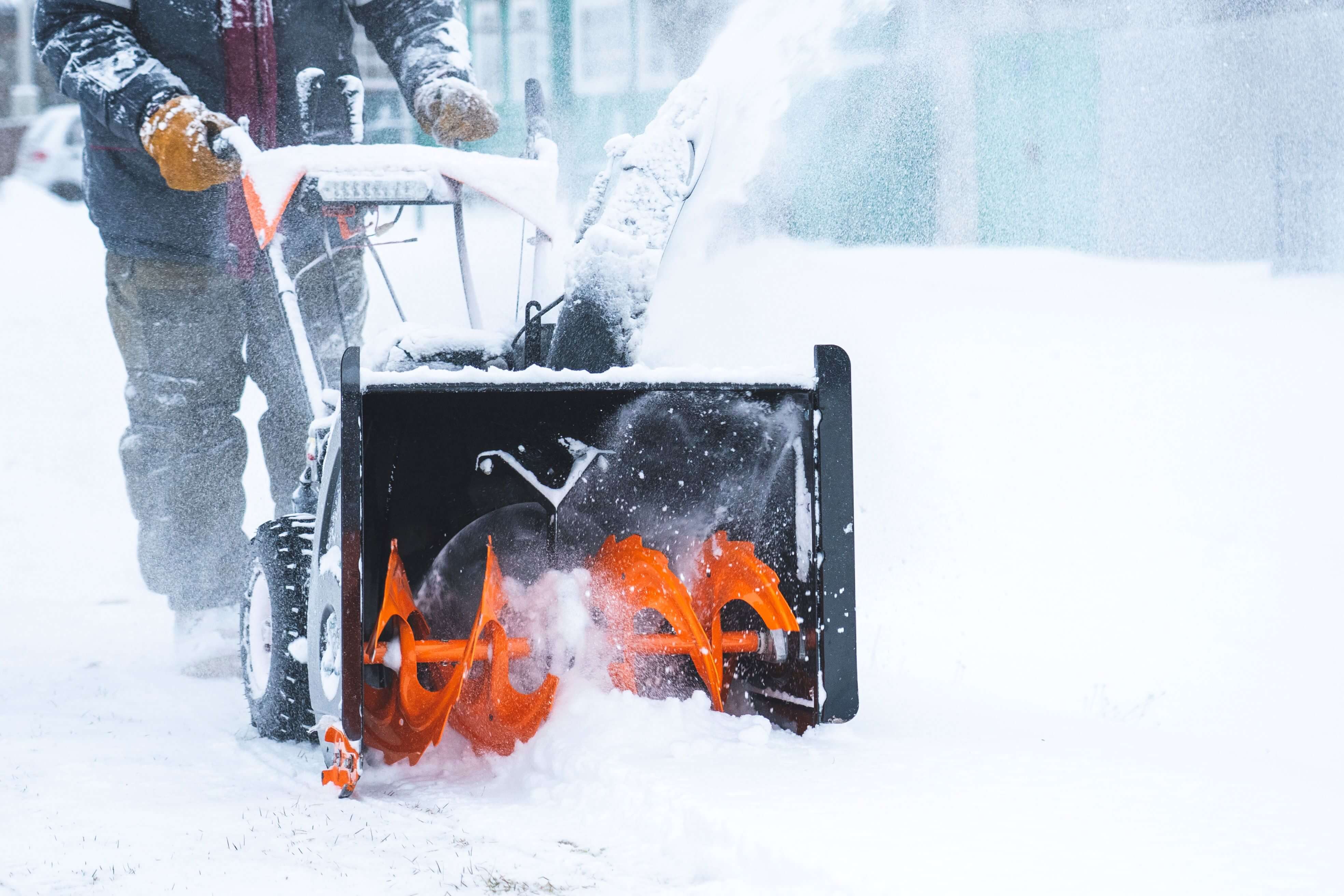 Crew Member Pushing Snow Blower 